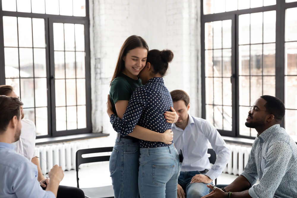 Beverly Hills Luxury Alcohol Rehab 1 Woman hugging her fellow patient in a group session