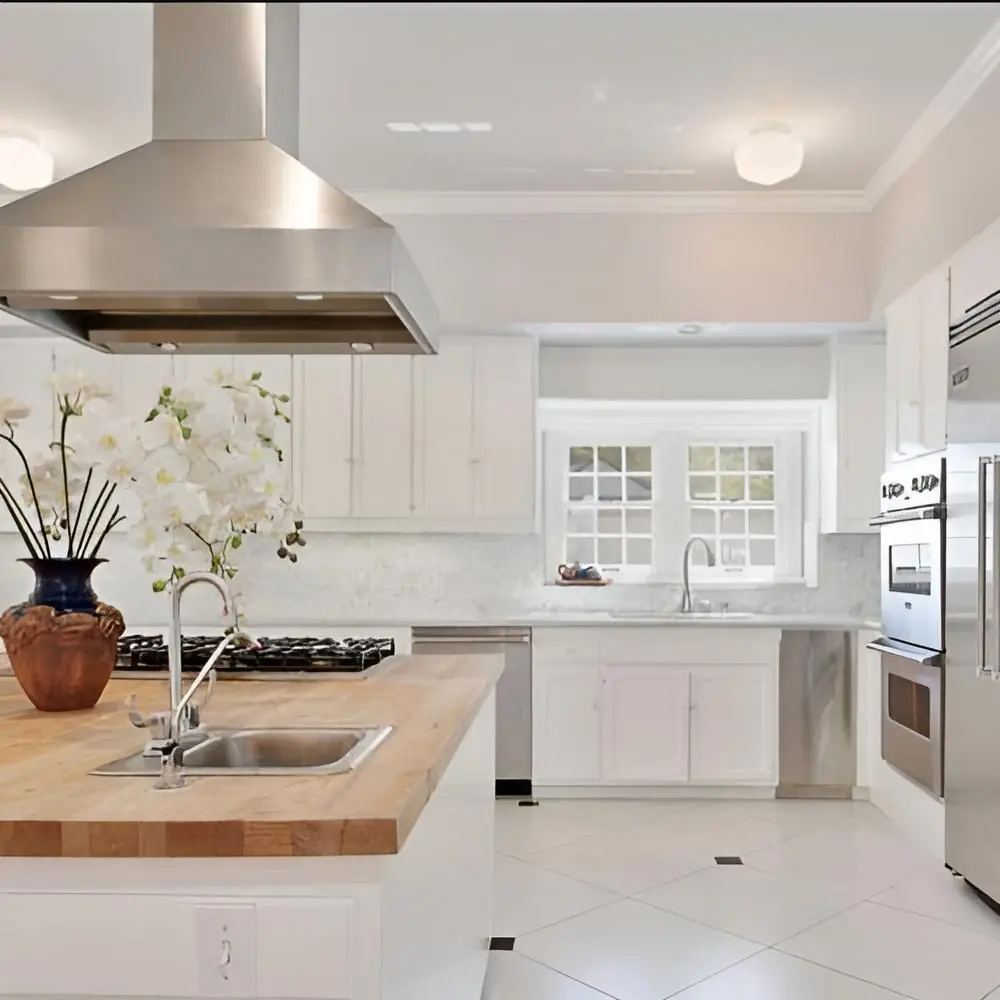 Kitchen with a central island and white cabinets at Safe Haven Recovery