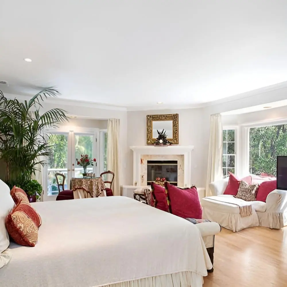 Bedroom with a fireplace and window-side seating at Safe Haven Recovery