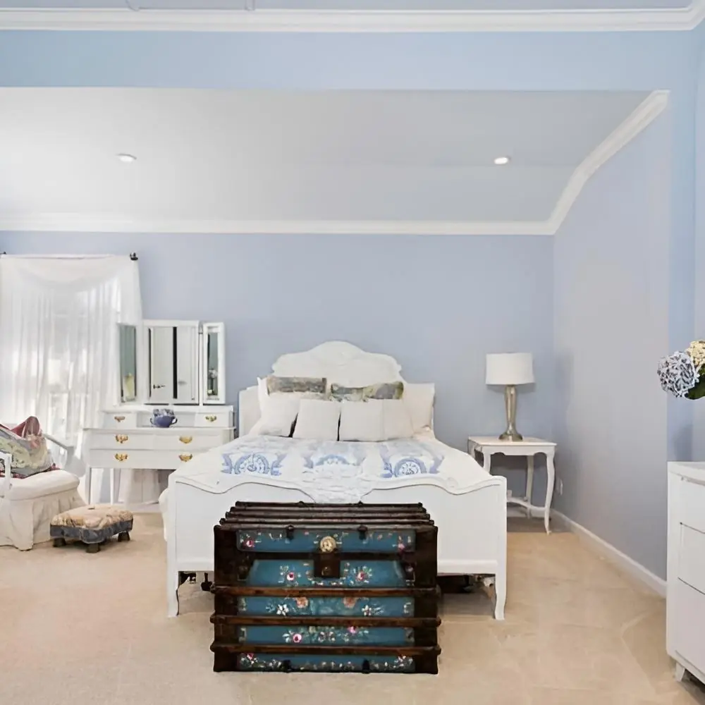 Bedroom with pale blue walls and white furnishings at Safe Haven Recovery