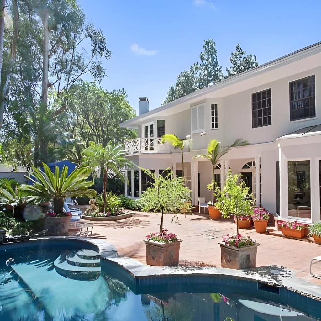 a beautiful pool with lush tropical plants at safe haven recovery luxury rehab