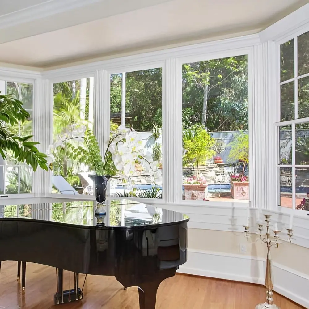 Grand piano beside garden-facing windows at Safe Haven Recovery