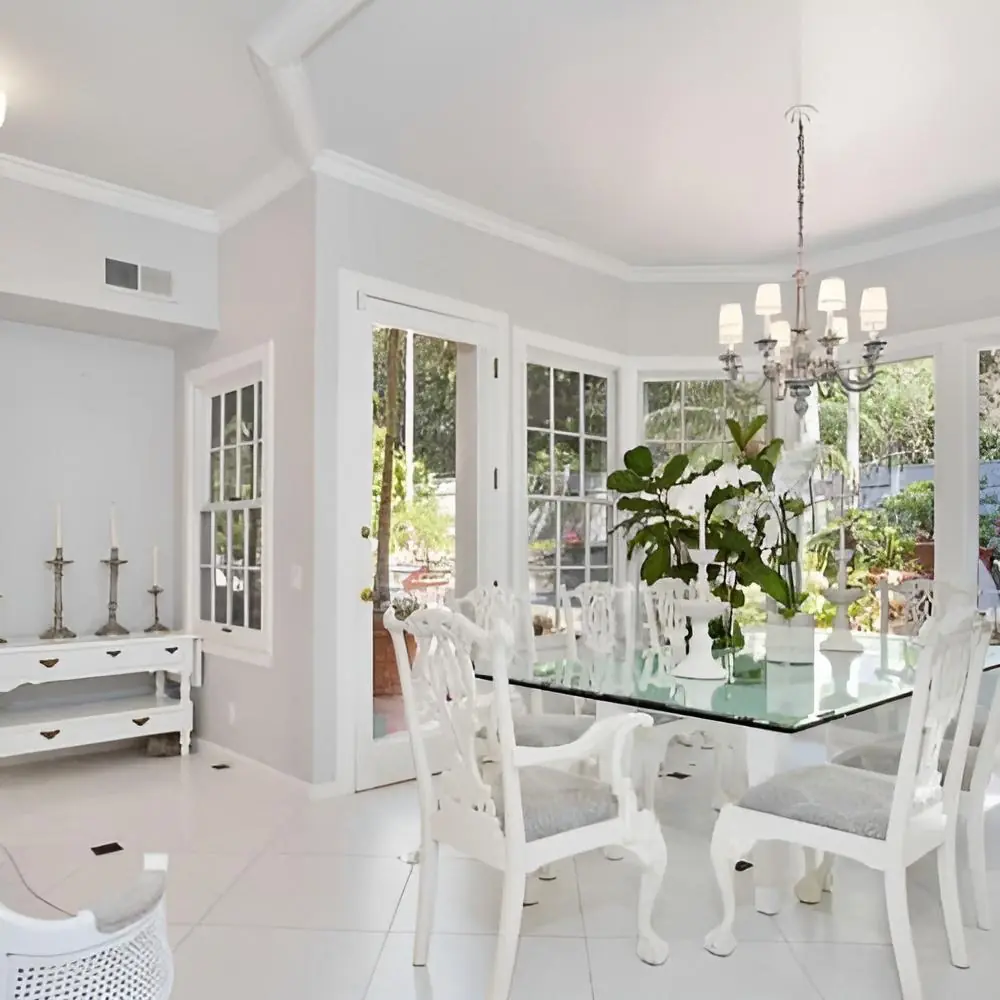 Bright dining area with a glass table and garden views at Safe Haven Recovery