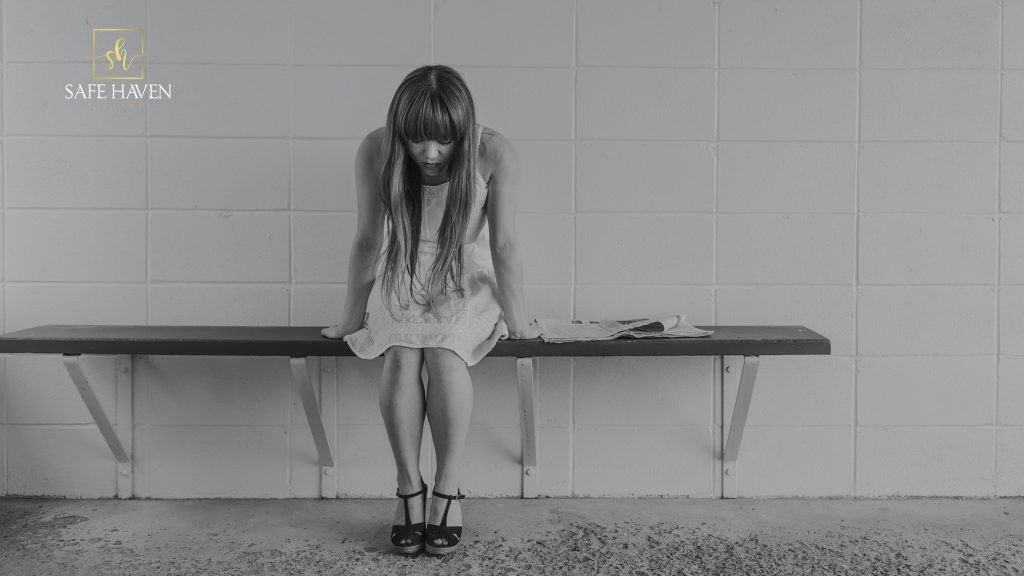 What Are the Signs of Drug Addiction? 1 Woman looks sad in a rehab center