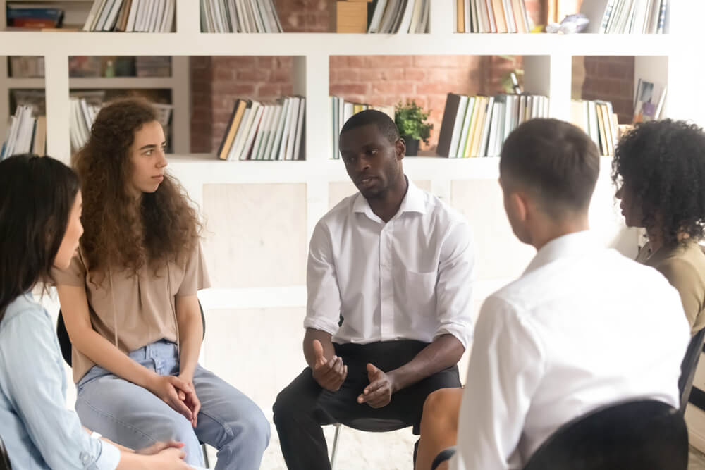Drug Detox Facility Beverly Hills 2 Man talking and explaining in a group session in rehab center