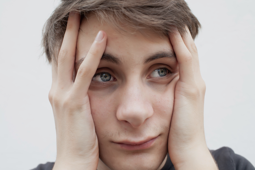 Weed Shakes: Are Weed Shakes Dangerous? 2 A distress boy holding his head