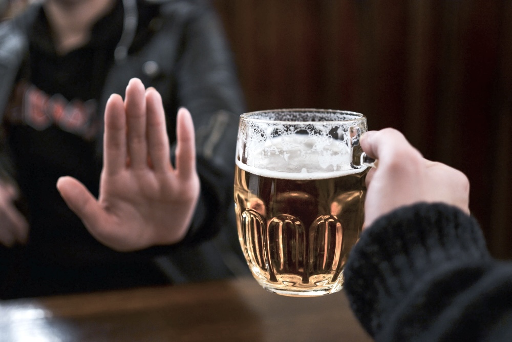 Are You Happier Without Alcohol? 5 Reasons Why 2 An individual declining an alcohol drink