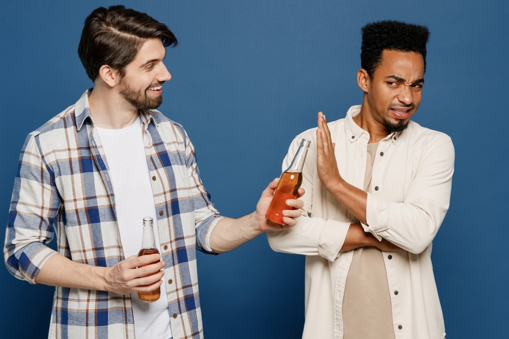 Are You Happier Without Alcohol? 5 Reasons Why 1 A guy declining an alcohol drink from a friend