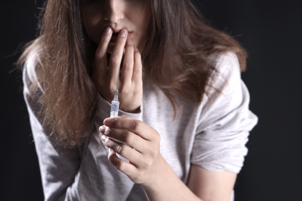 What Is a Speedball Drug? Dangers You Should Know 1 Troubled woman looking into an illegal drug