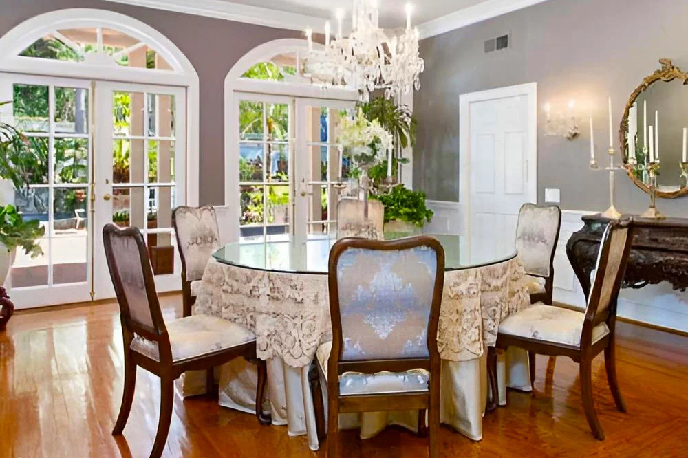 dining room at safe haven recovery with a round table, upholstered chairs and garden-facing doors