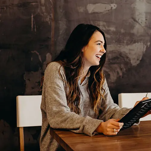 woman seated with a laptop during a conversation