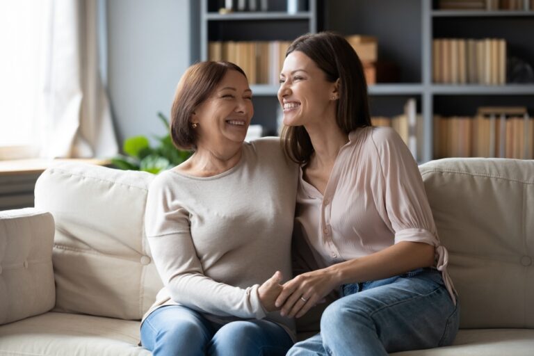 mother and daughter sitting on the couch celebrating sobriety from alcohol