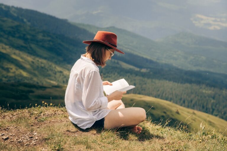 woman reading a book in nature for self-care