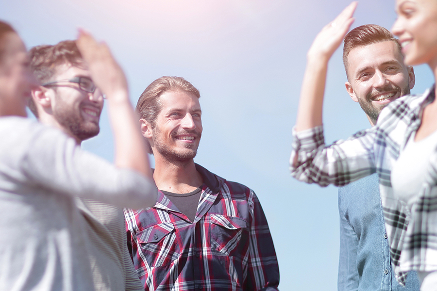 Alcohol Addiction Treatment in Beverly Hills, CA 1 Group of people high-fiving outdoors, symbolizing support and connection during alcohol addiction treatment