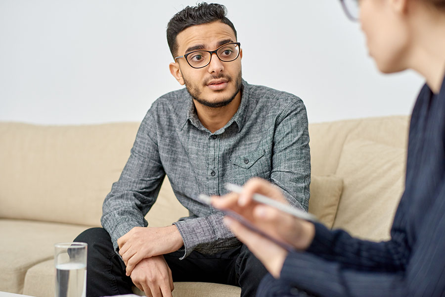 Alcohol and Drug Rehab That Accepts Aetna Insurance 2 Man in counseling session discussing insurance covered by Aetna for addiction treatment with a therapist