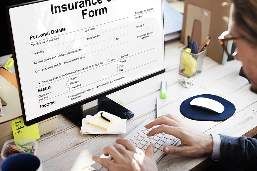 Blue Cross Blue Shield Insurance Coverage for Addiction Treatment Services 1 Person using a laptop to confidently fill out a confidential online form for Blue Cross Blue Shield insurance verification for addiction treatment at Safe Haven Recovery