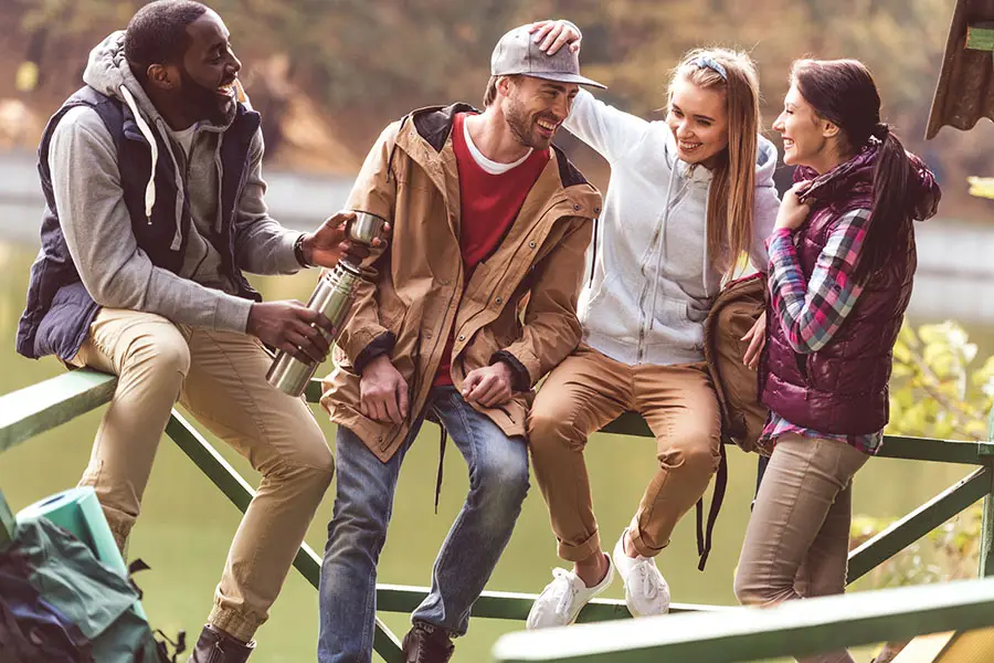 group of friends enjoying outdoor time by a lake, symbolizing recovery support after prescription drug addiction.