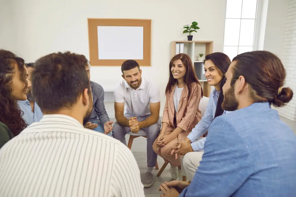 a diverse group of people participating in a therapy session together.