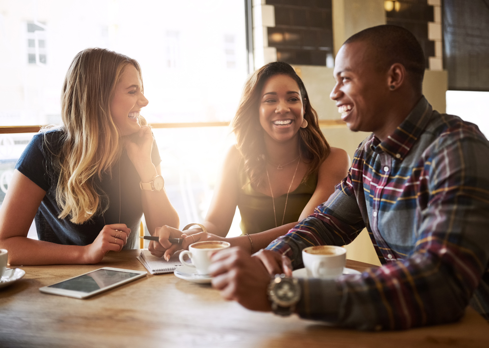 A group of friends catching up over coffee in a coffee shop.