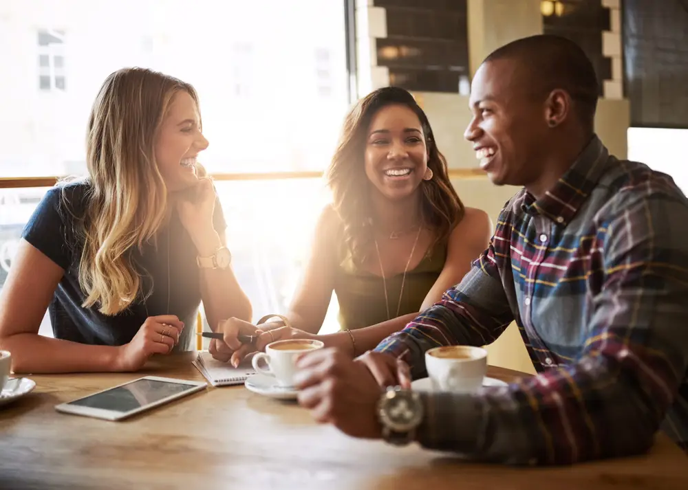 a group of friends catching up over coffee in a coffee shop.