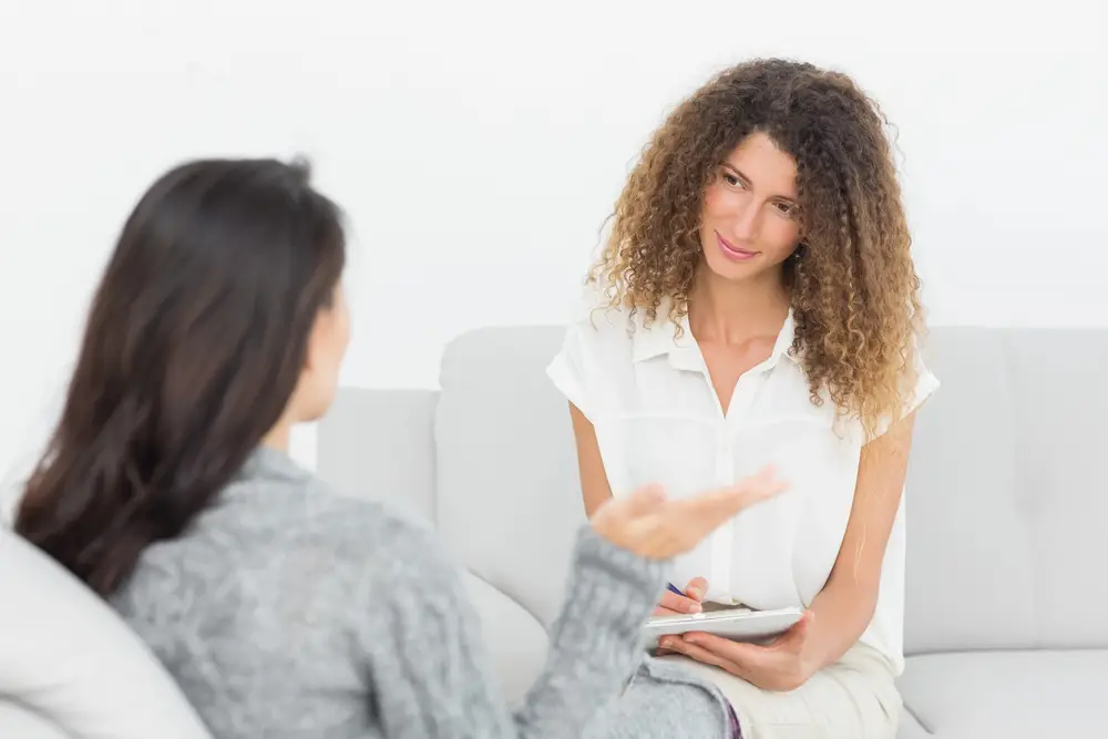 admissions staff discuss highmark insurance coverage with a patient during a medical office consultation.