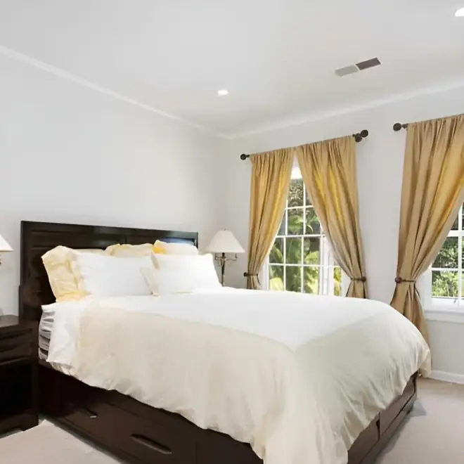 Home 3 bedroom with white bedding and gold curtains at safe haven recovery