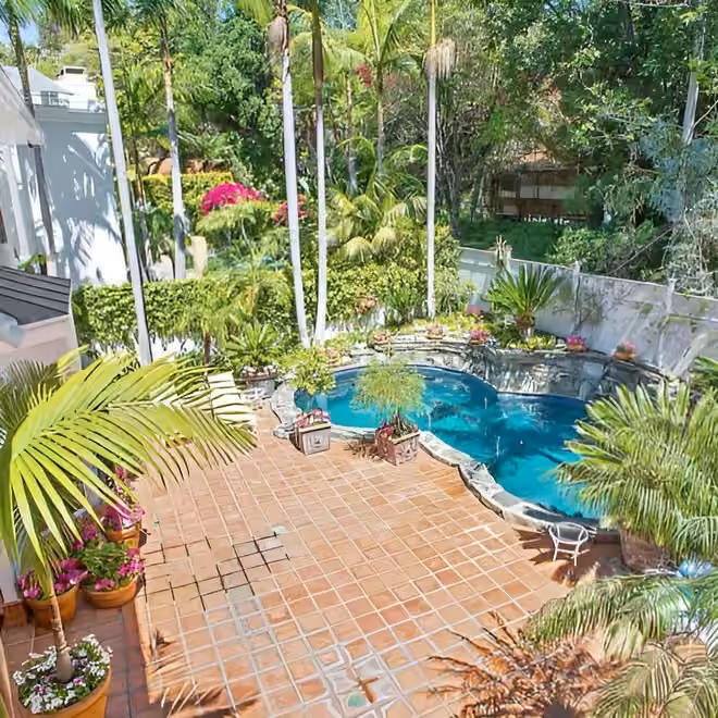 Home 5 garden courtyard with a pool and palm trees at safe haven recovery