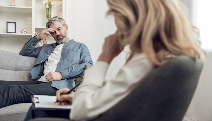 a troubled man suffering from substance abuse talking to a psychologist