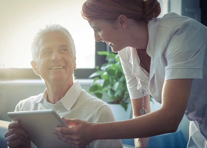 older adult speaking with a healthcare professional