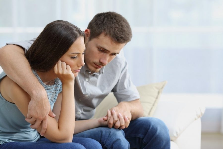 couple sitting close in emotional support, reflecting addiction quotes for loved ones during hard times
